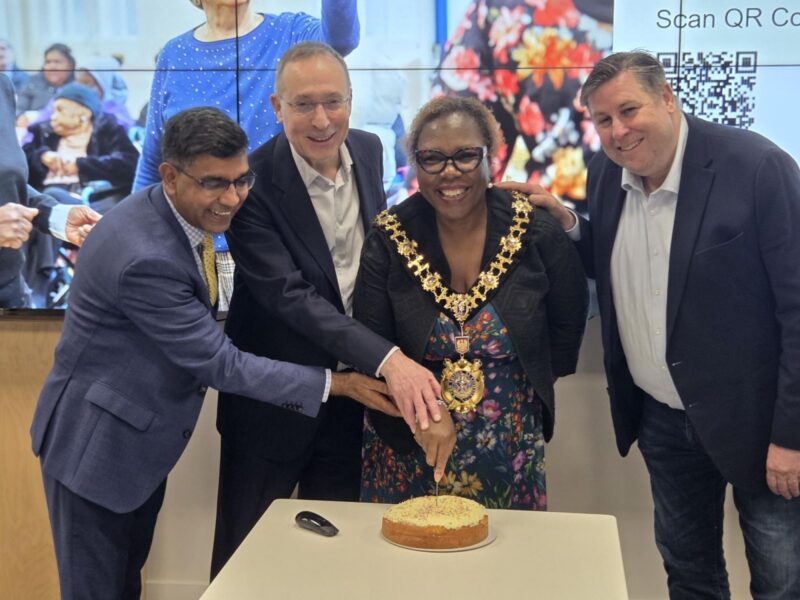 Helping H&F Mayor, Sharon Holder, to cut the cake at the Silver Social. 